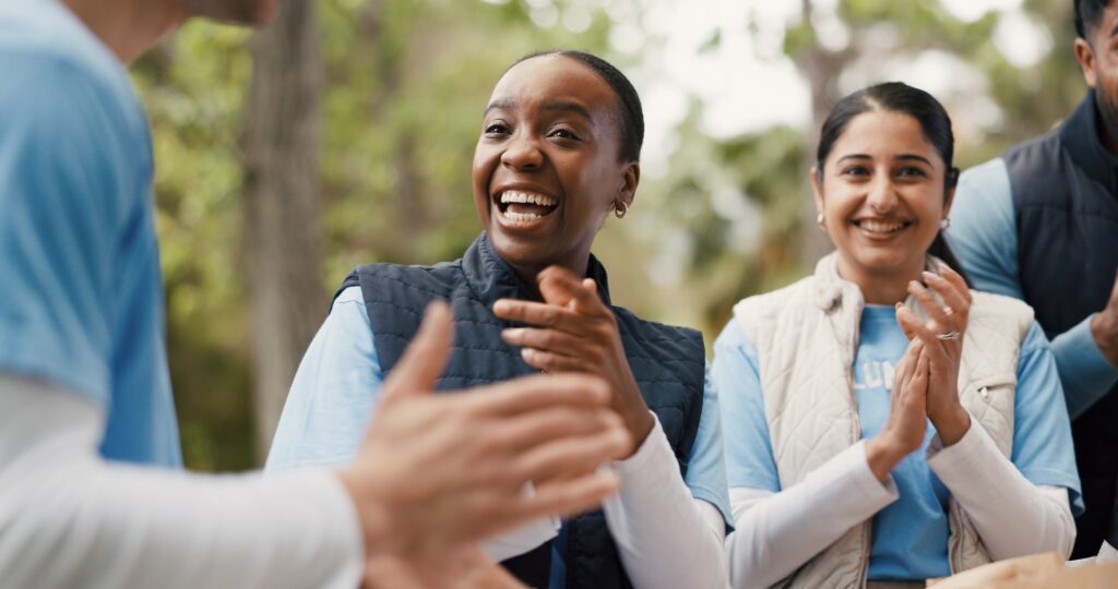 A group of fundraising volunteers talking to each other optimistically before an event.
